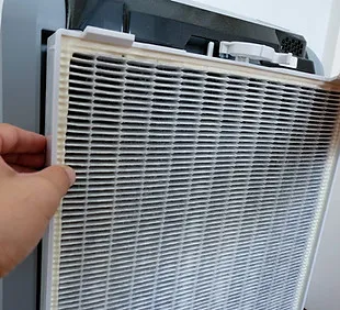 Technician replacing the HEPA filter of an air purifier